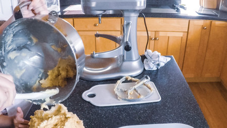 Step by step. Mother and daughter baking sugar cookies in the kitchen.