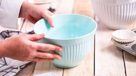 Mixing ingredients together in mixing bowl for blueberry muffins.の写真素材