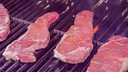 Step by step. Raw New York strip steak ready for outdoor grilling.の写真素材
