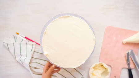 Flat lay. Frosting pink and purple cake with a white buttercream icing.の写真素材