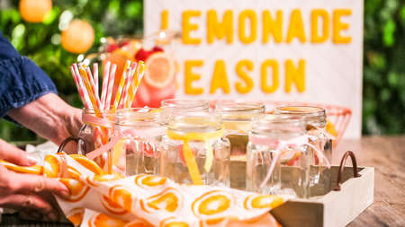 Raspberry lemonade garnished with fresh lemon and raspberries in drinking mason jars.の写真素材