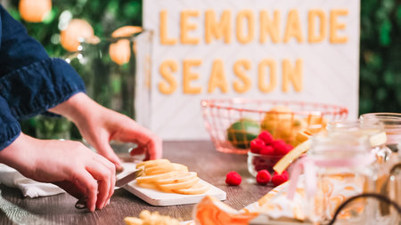 Step by step. Preparing raspberry lemonade with fresh lemons and raspberries in drinking mason jars.