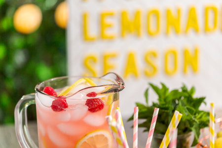 Raspberry lemonade garnished with fresh lemon and raspberries in drinking mason jars.の写真素材