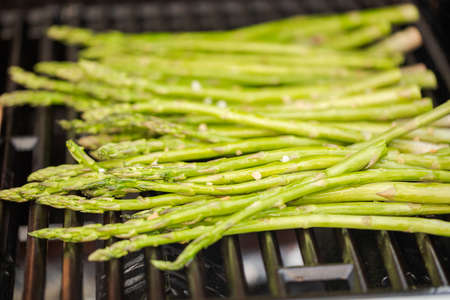 Grilling fresh asparagus on outdoor gas grill.の写真素材