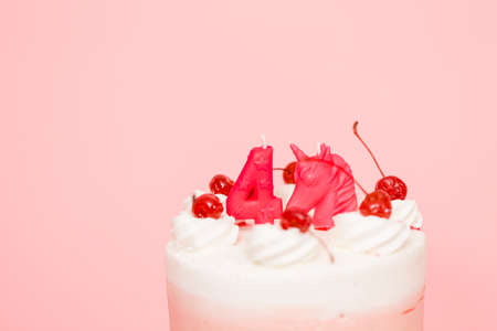 Birthday Spumoni cake on pink background.の写真素材