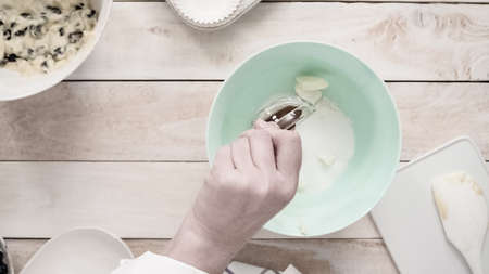 Mixing ingredients together in mixing bowl for blueberry muffins.の写真素材