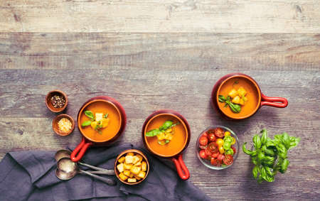 Roasted tomato soup with fresh basil and croutons.の写真素材