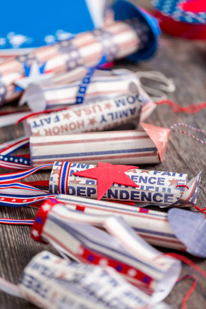 Paper firecrackers made from red, white and blue paper for July 4th celebration.