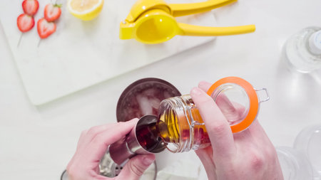 Step by step. Preparing Kentucky kiss burbon cocktail with fresh organic strawberries.