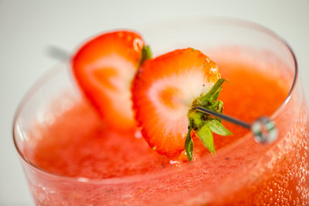 Kentucky kiss burbon cocktail garnished with fresh strawberries.
