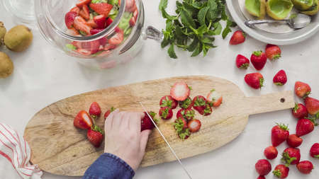 Step by step. Slicing fressh organic fruits for infused water.の写真素材