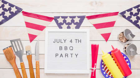 July 4th BBQ Party sign on memo board with July 4th decorations.の写真素材