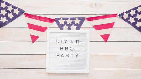 July 4th BBQ Party sign on memo board with July 4th decorations.の写真素材