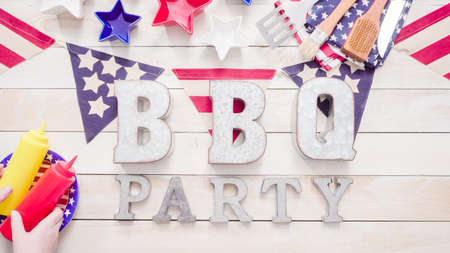 BBQ Party sign with July 4th decorations on a wood boards.の写真素材