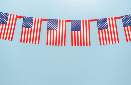 July 4th theme paper garland on blue background.