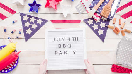 July 4th BBQ Party sign on memo board with July 4th decorations.の写真素材