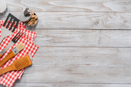Background with BBQ cooking tools on wood background.の写真素材