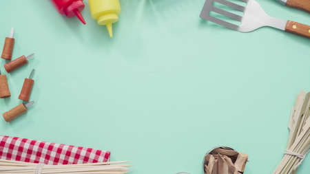 Variety of grilling tools on blue background.の写真素材