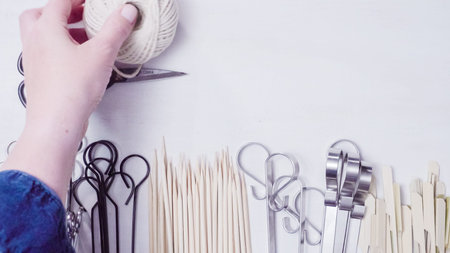 Steel and wood skewers on a white painted wood background.の写真素材