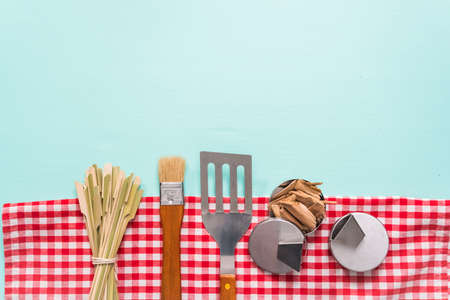 Variety of grilling tools on blue background.の写真素材