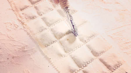 Making Italian raviolis from scratch at the Italian party.の写真素材