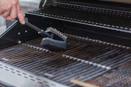 Cleaning outdoor gas grill before next grilling.の写真素材