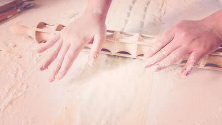 Making Italian raviolis from scratch at the Italian party.の写真素材