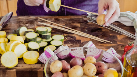 Step by step. Preparing veggie skewers for outdoor grilling.の写真素材