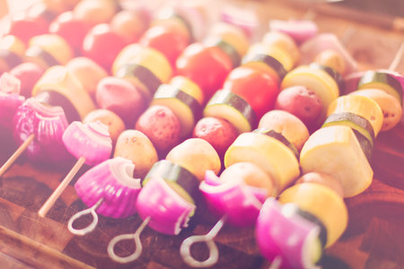 Preparing veggie skewers for outdoor grilling.の写真素材