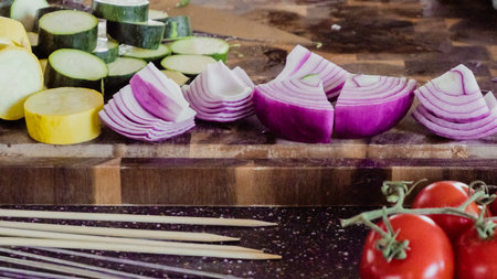 Step by step. Slicing fresh organic vegetables for veggie kebabs.