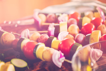Preparing veggie skewers for outdoor grilling.の写真素材