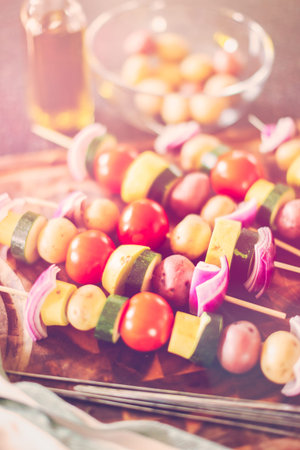 Preparing veggie skewers for outdoor grilling.