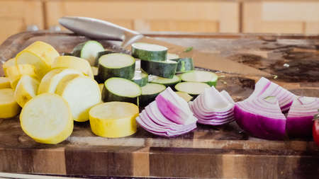 Step by step. Slicing fresh organic vegetables for veggie kebabs.の写真素材