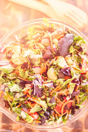 Preparing fresh salad with organic veggies.の写真素材