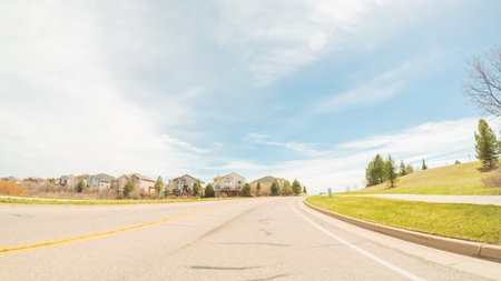 POV- Driving on paved road in suburban neighborhood in Colorado.