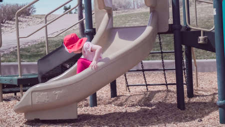 Little girl playing on outdoor children playground in suburban neighborhood.の写真素材