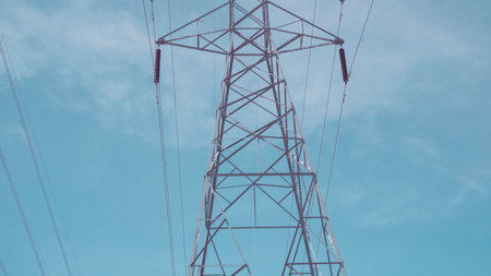 Big towers with power lines in suburban neighborhood.