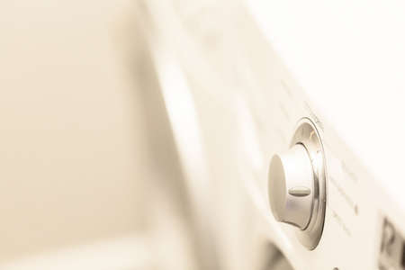 Doing laundry in laundry room of modern single family house in suburbs.の写真素材