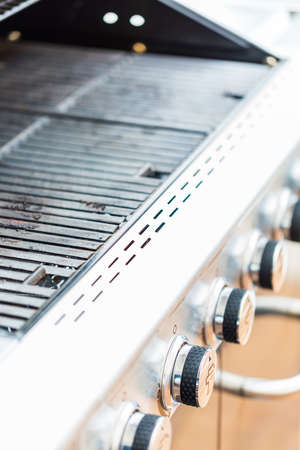 Close up of control knobs on outdoor 6 burner gas grill.の写真素材