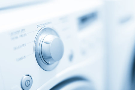 Doing laundry in laundry room of modern single family house in suburbs.