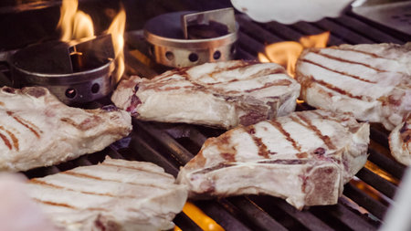 Cooking pork chops with pineapples on gas grill in the Summer.の写真素材
