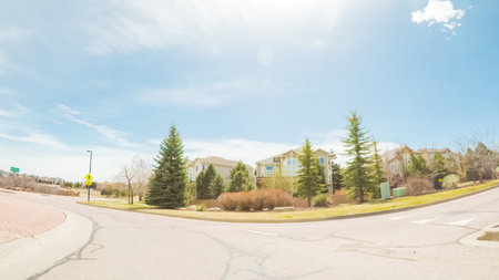 POV- Driving on paved road in suburban neighborhood in Colorado.