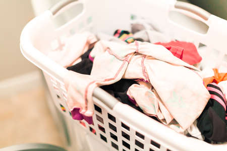 Doing laundry in laundry room of modern single family house in suburbs.の写真素材