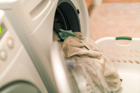 Doing laundry in laundry room of modern single family house in suburbs.の写真素材