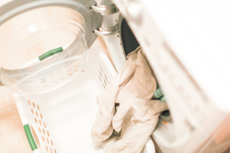 Doing laundry in laundry room of modern single family house in suburbs.