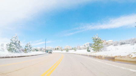 Driving on suburban road after Spring snow storm.