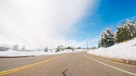 Driving on suburban road after Spring snow storm.