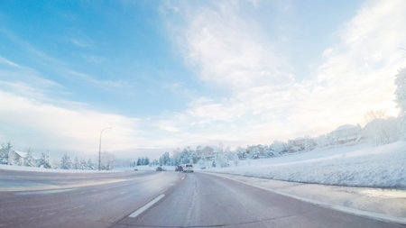 Driving on suburban road after Spring snow storm.の写真素材
