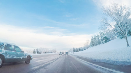 Driving on suburban road after Spring snow storm.