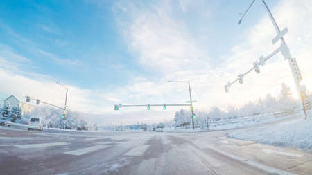 Driving on suburban road after Spring snow storm.の写真素材